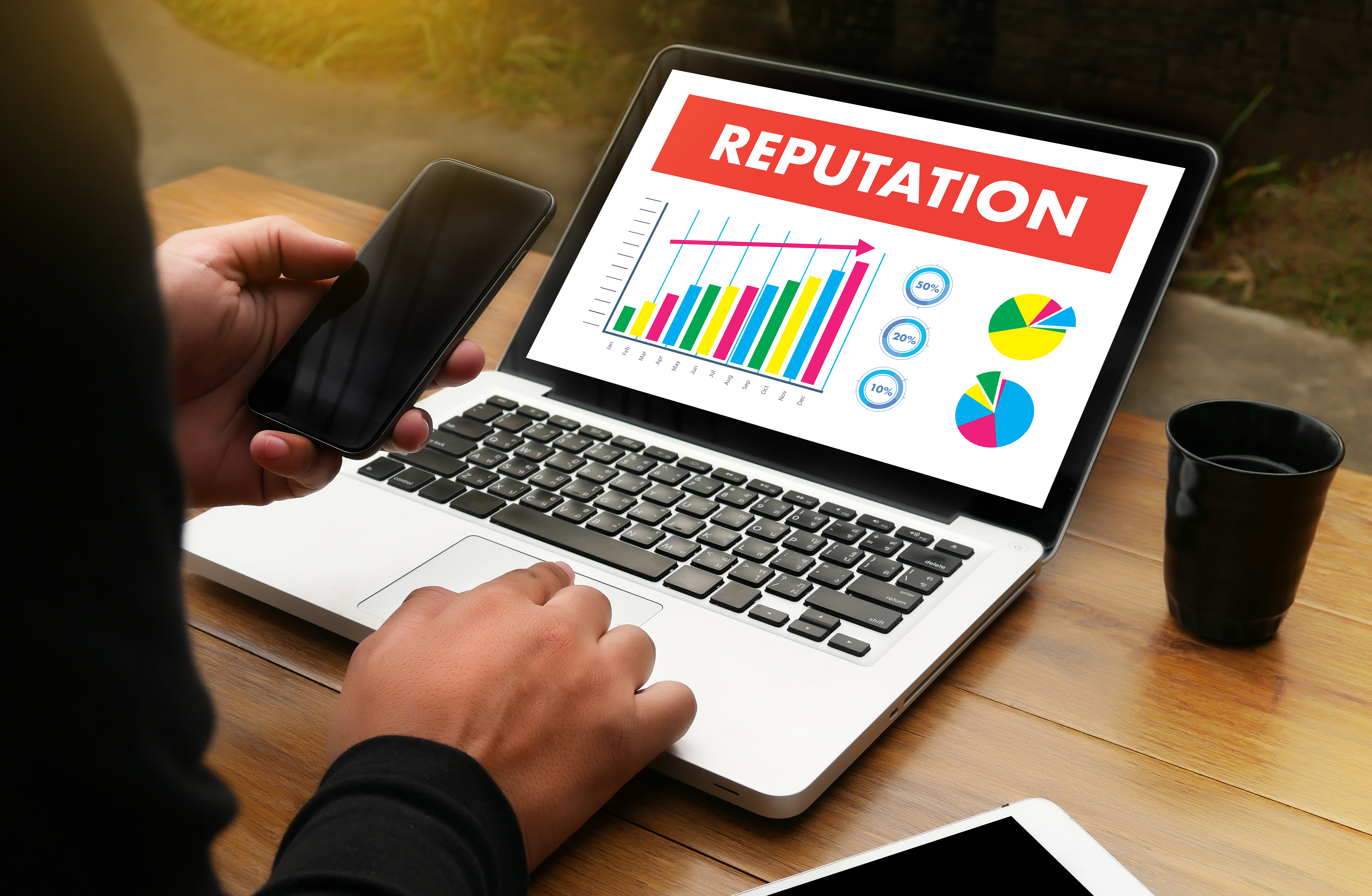 A graph on a laptop screen indicates reputation growth over time